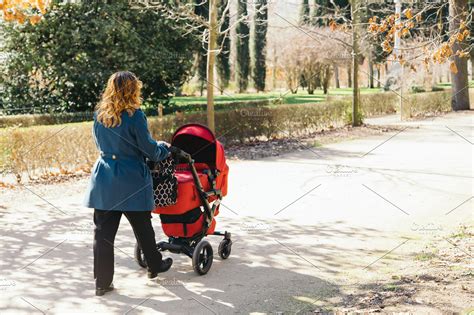 Mother Walking With Baby Stroller High Quality Stock Photos