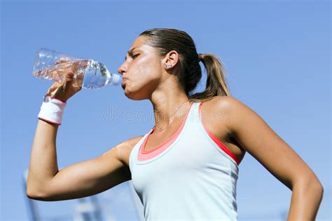 Young Beautiful Athlete Drinking Water After Exercising Stock Photo