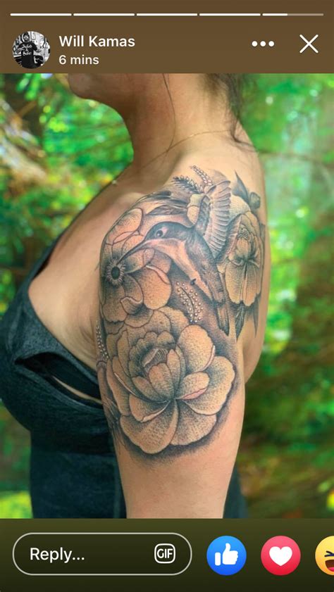 A Woman With A Flower Tattoo On Her Arm