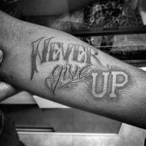 This tattoo can be meaningful, especially once you realize the meaning behind a rose tattoo! 60 Never Give Up Tattoos For Men - Phrase Design Ideas