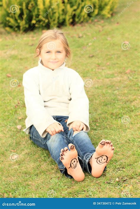 Girl With Smileys On Toes And Soles Stock Photo Image Of Lying