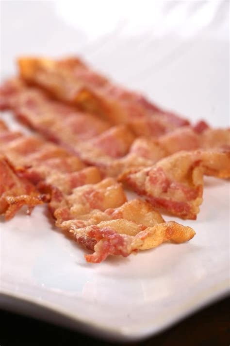 Some recipes recommend baking bacon at 425 degrees f, 375 degrees f, or starting the bacon in a cold oven, but i found that a preheated 400 degrees f is the best temperature. How Long to Bake Bacon? - Food Fanatic