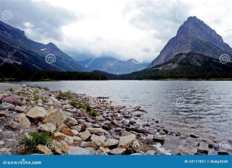 Clear Lake And High Mountains In Glacier National Park Stock Image