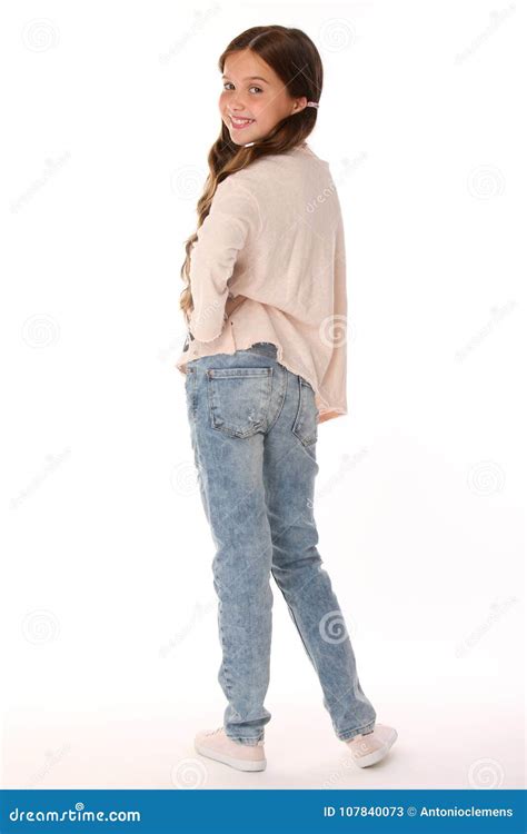 Happy Beautiful Smiling Slender Child Girl In Blue Jeans Stock Image