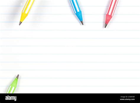 Colorful Pencils On Notebook Lined Paper Background With Copy Space