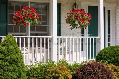 A Beautiful Landscaped American Front Porch With White