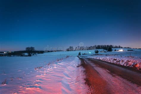 Snow Covered Fields Along A Dirt Road At Night In Rural York Co Stock
