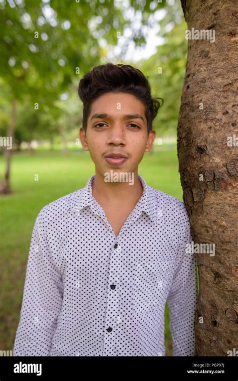 Portrait Of Young Indian Teenage Boy Relaxing At The Park Stock Photo