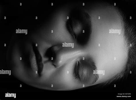Beautiful Female Face With Closed Eyes In Dark Sleeping Monochrome