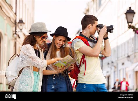 Three Friends Together With City Map And Camera Stock Photo Alamy