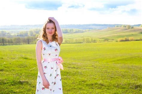 Cute Young Blonde Woman In Green Field At Summer Or Spring Sunset Stock