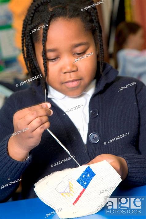 Primary School Pupil Learning To Sew During A Needlework Lesson At