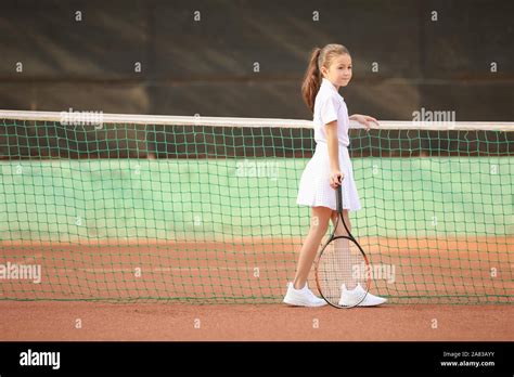 Little Girl Playing Tennis On Court Stock Photo Alamy