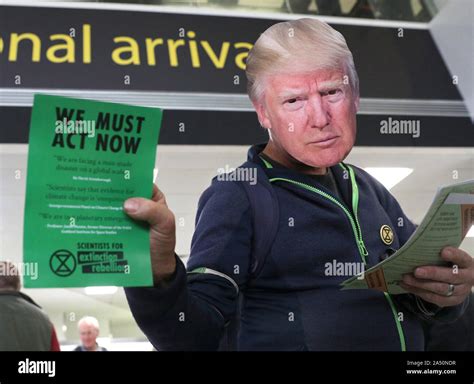 Extinction Rebellion Protester Dressed As Donald Trump Hands Out