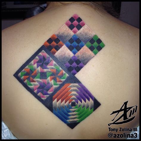 A Colorful Tattoo On The Back Of A Womans Shoulder