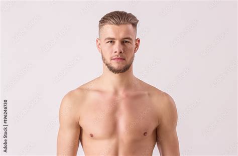 Studio Shot Of Handsome Naked Man Looking To Camera While Standing