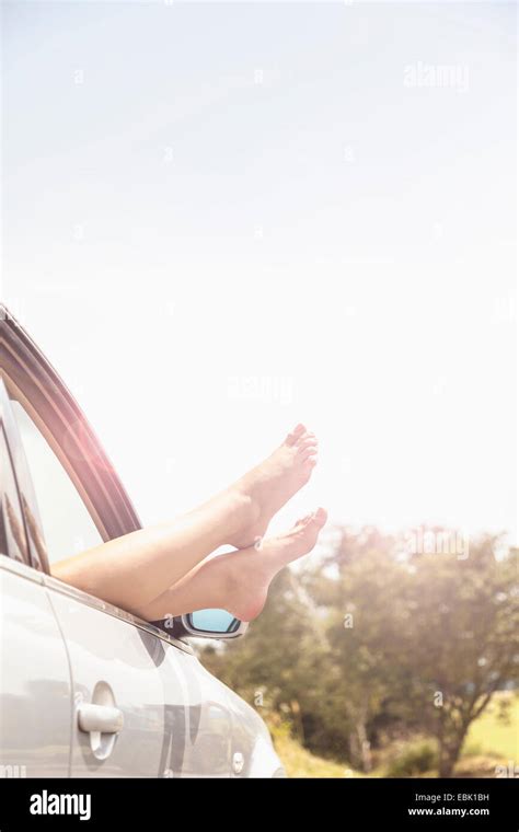 Young Womans Bare Feet Resting On Car Window Stock Photo Alamy
