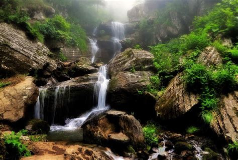 Waterfalls In Rocky Forest