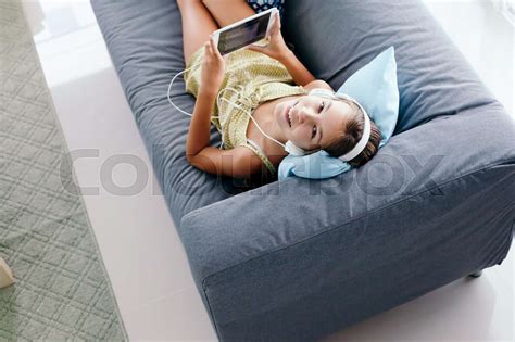 Tween Girl Relaxing On Couch At Home Stock Image Colourbox