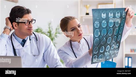 The Two Doctors Examining X Ray Images Of Patient For Diagnosis Stock