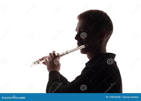 Silhouette Of A Playing Musician With A Flute The Guy Gives Out Sounds