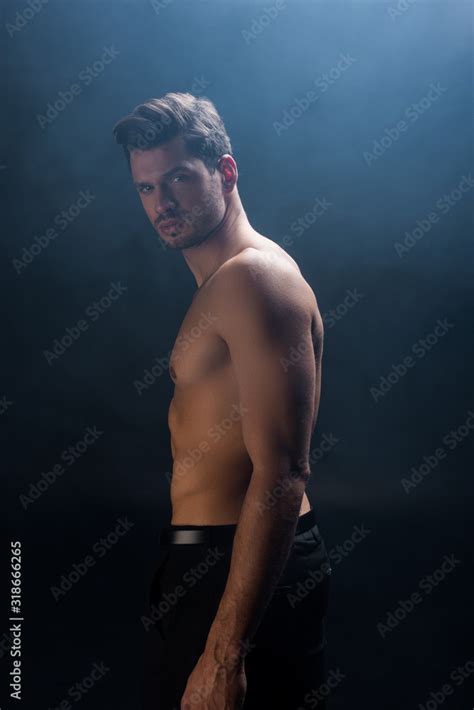 Side View Of Shirtless Man Looking At Camera On Black Background With Smoke Stock Photo Adobe