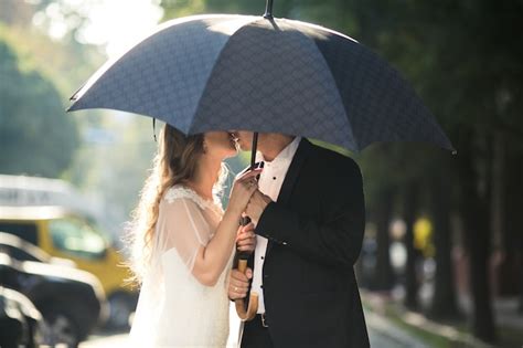 Free Photo Couple Under Umbrella Kissing
