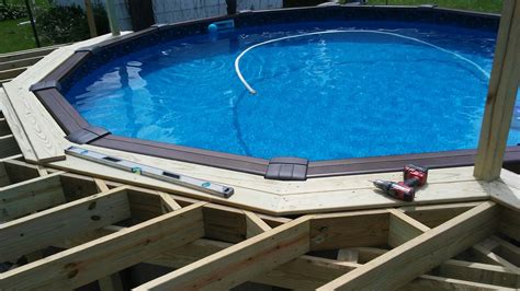 This swimming pool above ground pool deck ideas on a budget stays in the ground, then again with the above ground pool with dark wooden deck. Deck ideas | Diy pool, Pool deck plans, Swimming pool decks
