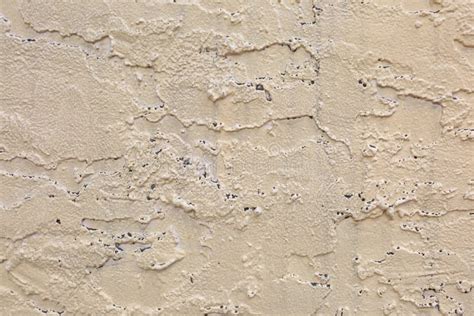 Exterior Tan Wall With Rough Stucco And Holes Texture Stock Image