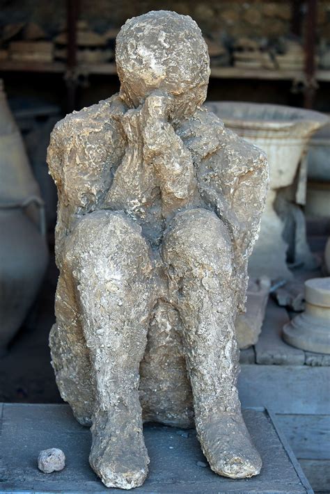 plaster cast of volcano victim in pompeii italy encircle photos
