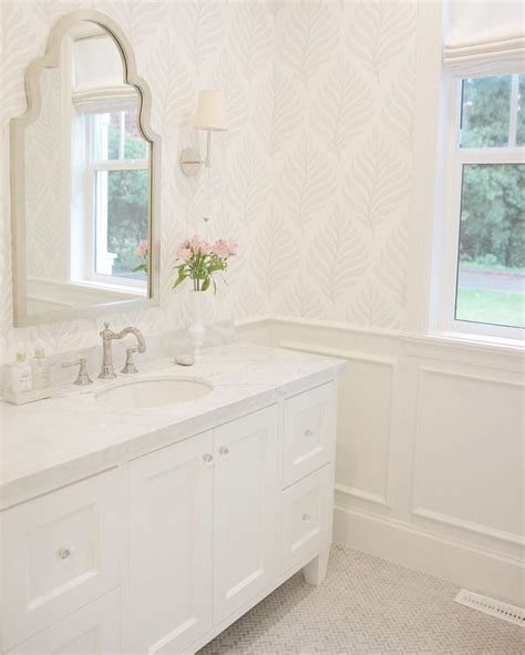 Marble baths and counter surfaces are a fashionable addition to a bathroom that wants to make a statement. neutral traditional bathroom decor with white vanity and ...