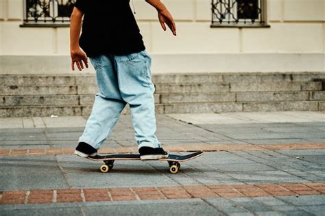 Premium Photo Skateboarder Ride On Skateboard At City Street Close Up