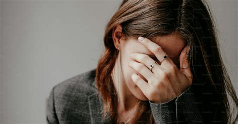 a woman covering her face with her hands photo sad mood image on unsplash