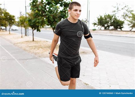 A Young Man Makes A Morning Jog In The Streets Sports Training Stock