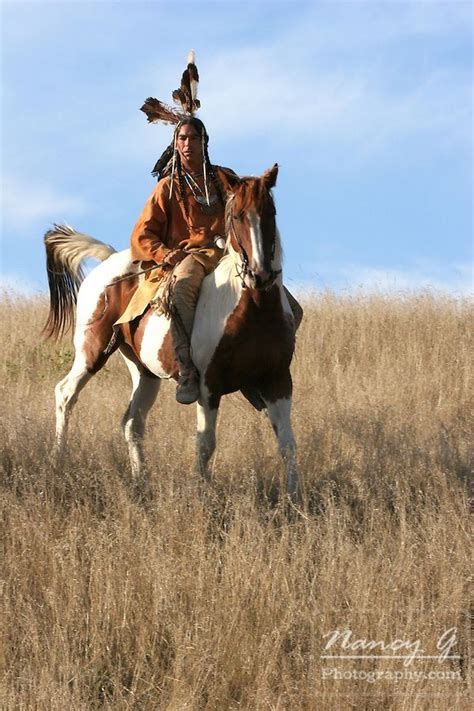 A Native American Indian Man On Horseback Riding The Prairie Of South