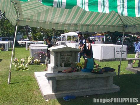 Supporters offer a prayer at the tomb of former president corazon aquino at the manila memorial park in sucat, paranaque on saturday paggunita ng undas sa manila memorial park, naging payapa. Manila Memorial Park