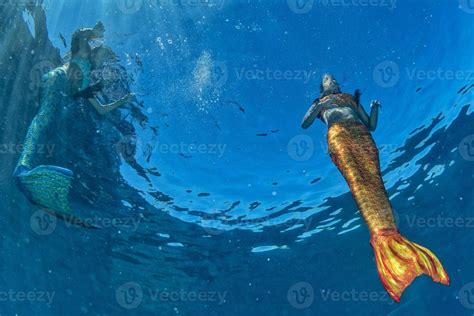 Two Mermaid Swimming Underwater In The Deep Blue Sea 20347076 Stock