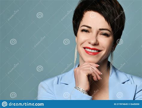 Portrait Of Beautiful Smiling Short Haired Brunette Woman In Blue Business Smart Casual Suit And