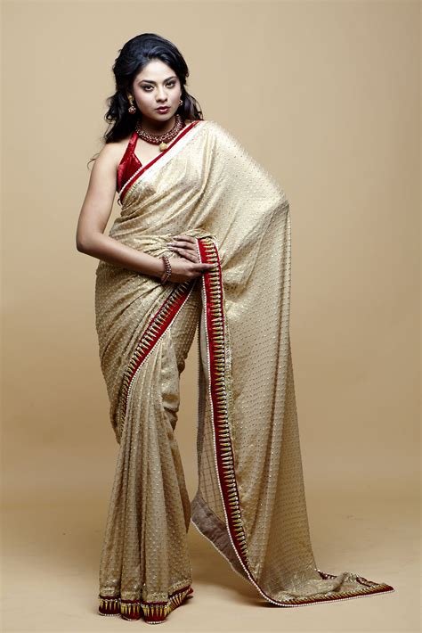 golden sari with a touch of red blends beautifully with that wow blouse model aishvarrya