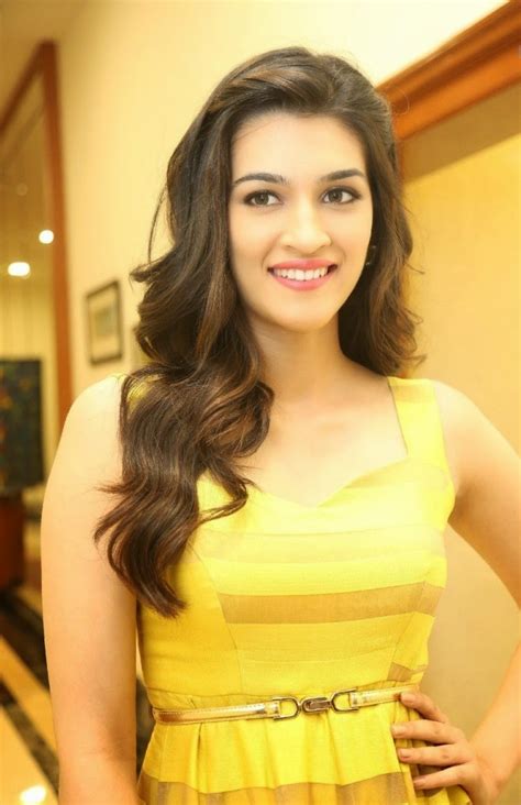 Beautiful Indian Girl Kriti Sanon Smiling Stills In Yellow Dress