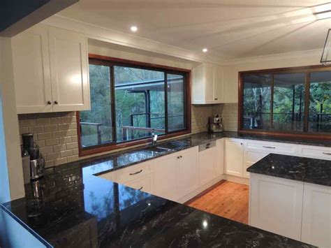 Pendant lights above the kitchen island bench are a classic element of a french provincial space. French Provincial Kitchens - Cut Above Kitchens & Cabinets