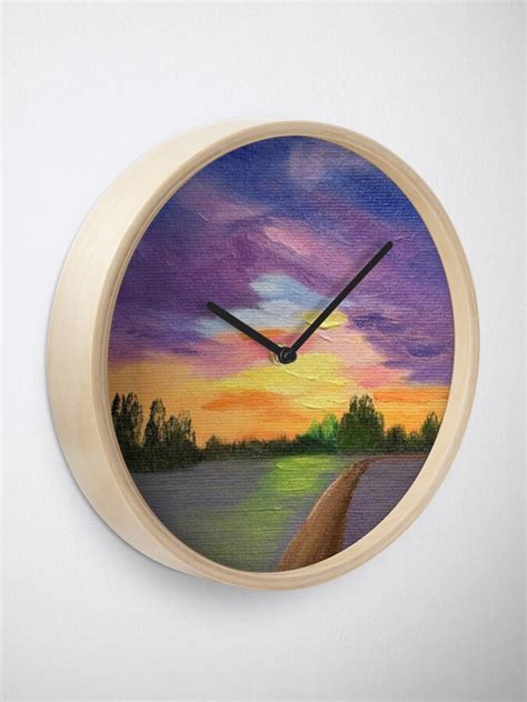 A Clock With A Painting Of A Sunset On The Outside And Trees In The