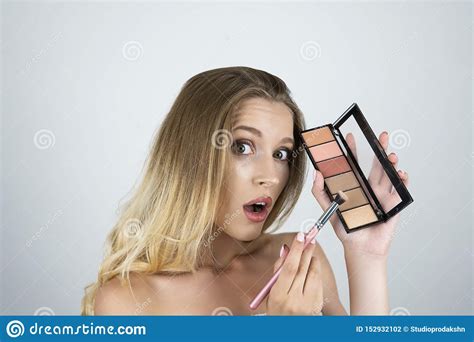 Beautiful Young Blond Woman Applying Eyeshadow On The
