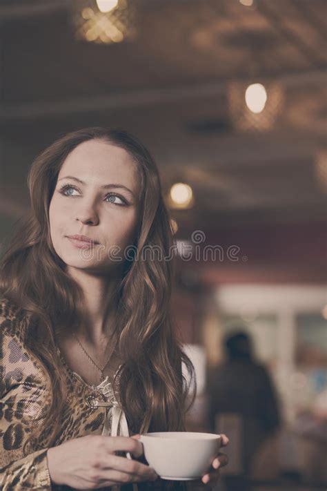 A Young Beautiful Girl Waiting For A Cup Of Tea In A Cafe Stock Photo