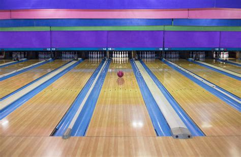 Large Bowling Alley With A Ball Rolling Down The Lane Stock Photo