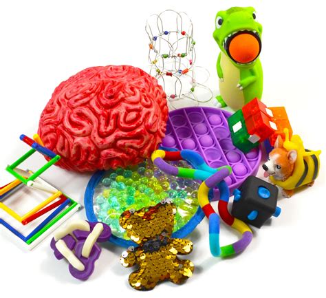 There Are Many Different Toys And Items On The Table Including A Brain