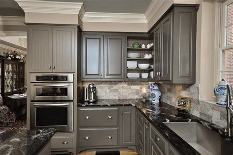 Dip one end of the grout float into bucket and apply to the wall, using enough pressure to work grout into the spaces. Kitchen Traditional With Black Marble Backsplash Beige ...