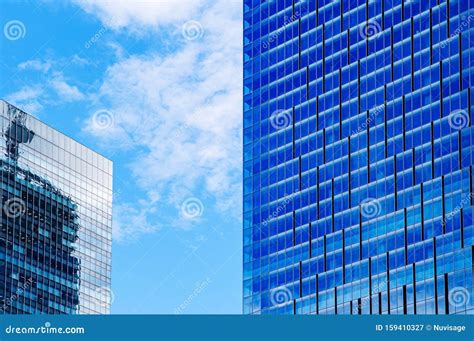 Modern Glass Wall Skyscrapers In Business District Against Bright Blue