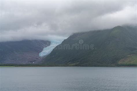 Norwegian Fjord Landscape With The Swartisen Glacier On An Overcast Day