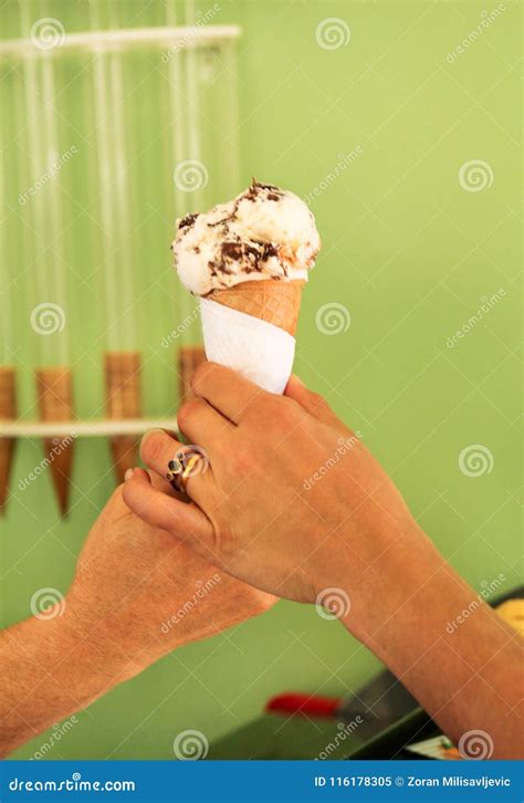 Two Female Hands Holding A Vanilla With Chocolate Ice Cream Cone Woman Sells Ice Cream In